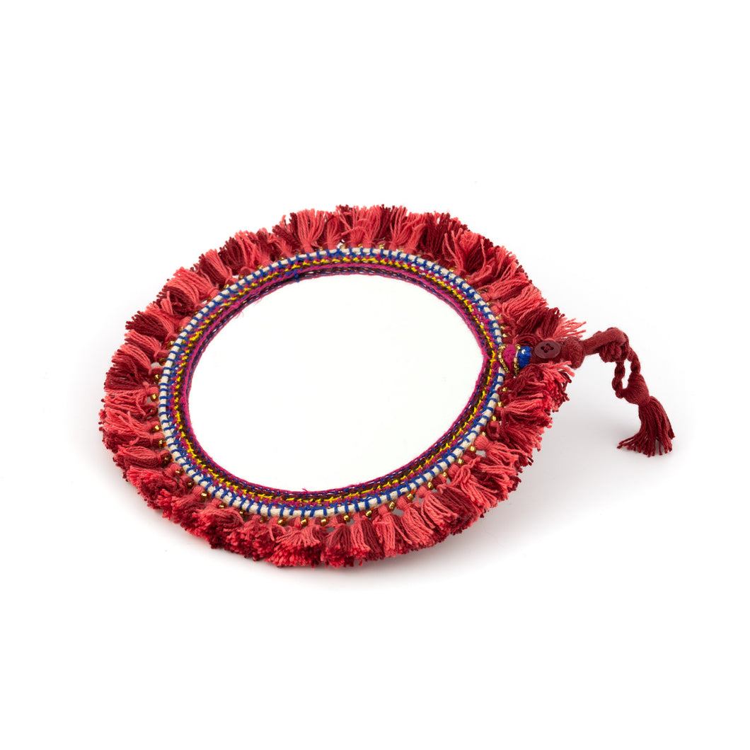 Tvåsidig spegel dekorerad med garn och pärlor. Med snöre för upphängning.  Färg: röd  Storlek: 15 cm i diameter.